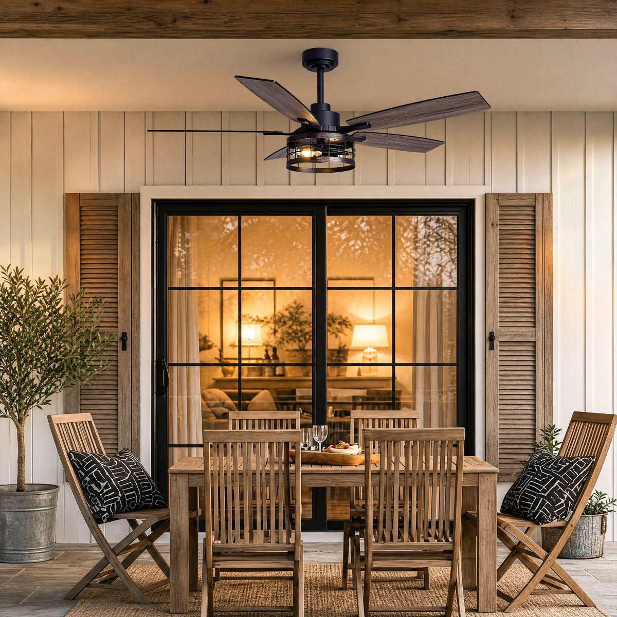 52" Black caged ceiling fan on outdoor patio — farmhouse fandelier with light, wooden dining area, rustic decor | Sofary Lighting
