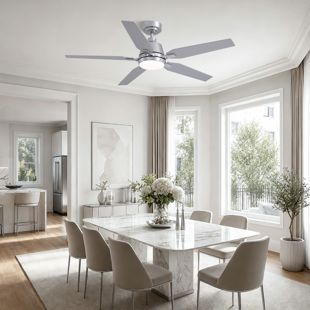 Modern chrome fandelier in dining room — white marble table, gray upholstered chairs, floral centerpiece, elegant bright dining space