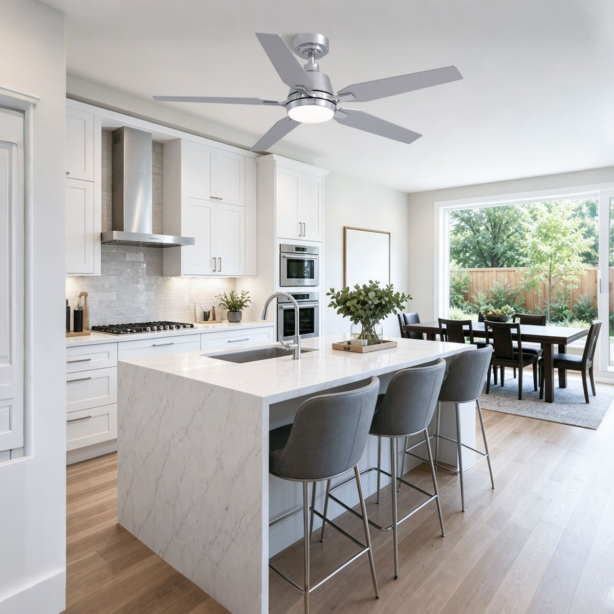 Modern kitchen island with chrome fandelier — white marble countertop, gray bar stools, stainless steel appliances, bright kitchen lighting