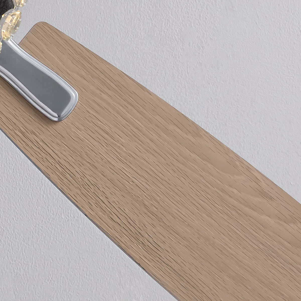 Close-up of wood grain fan blade — natural wood texture, rounded edge, chrome metal connector, elegant ceiling fan craftsmanship | Sofary Lighting