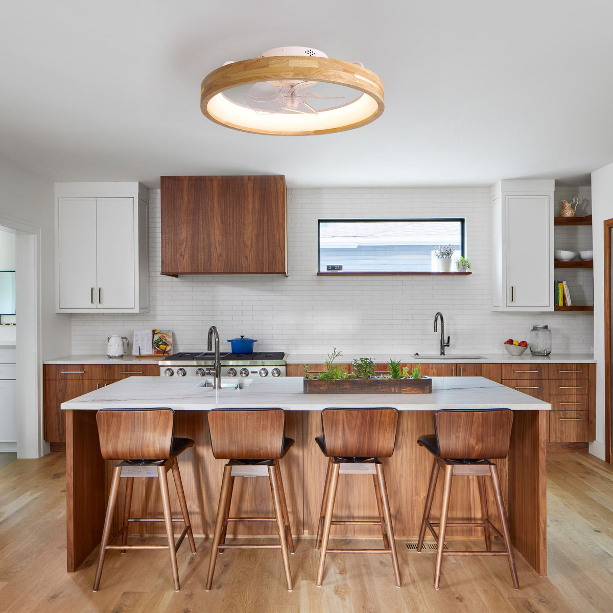 Aeria Modern Ceiling Fan over kitchen island — wood and white cabinetry, stone countertop, wood stools, coastal vibe | Sofary Lighting