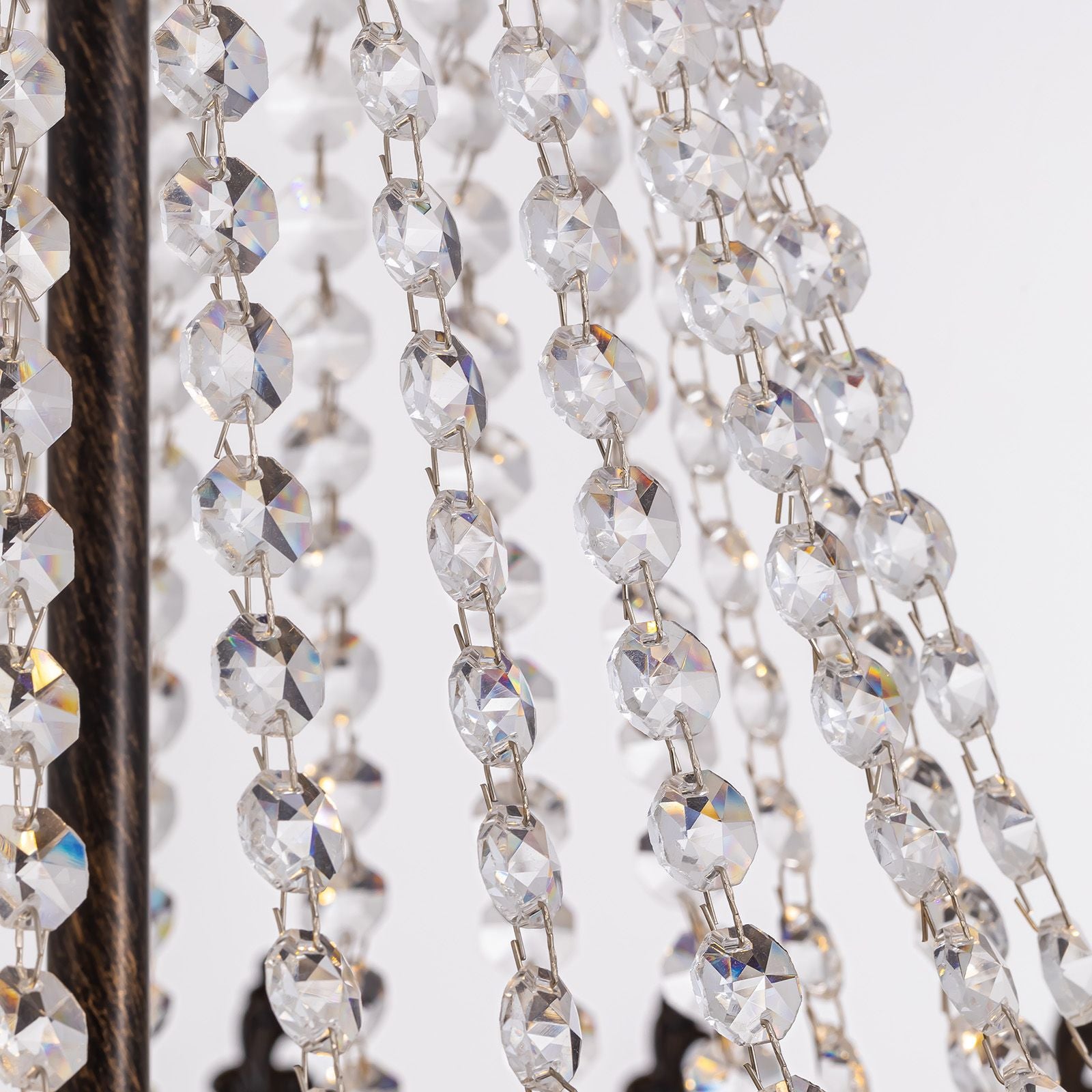 Aerian K9 crystal chandelier close-up — faceted crystal bead chains, light-refracting prisms, antiqued bronze frame, vintage luxury craftsmanship, hand-strung detailing | Sofary Lighting