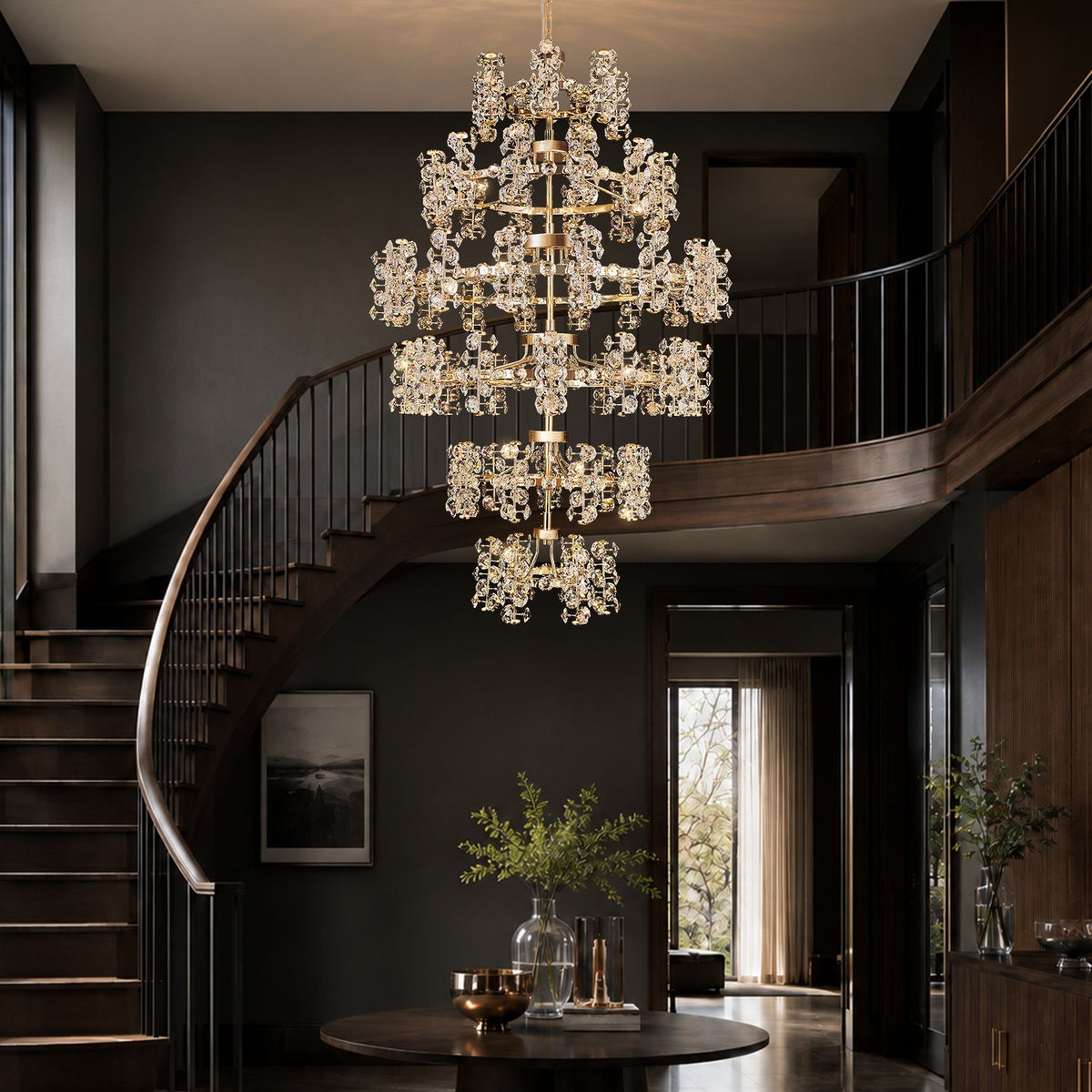 Aeriol Grand Staircase Chandelier beside sweeping curved staircase — dark wood steps, glass railing, multi-tier crystal drops follow architectural flow, creating vertical gallery of light | Sofary Lighting