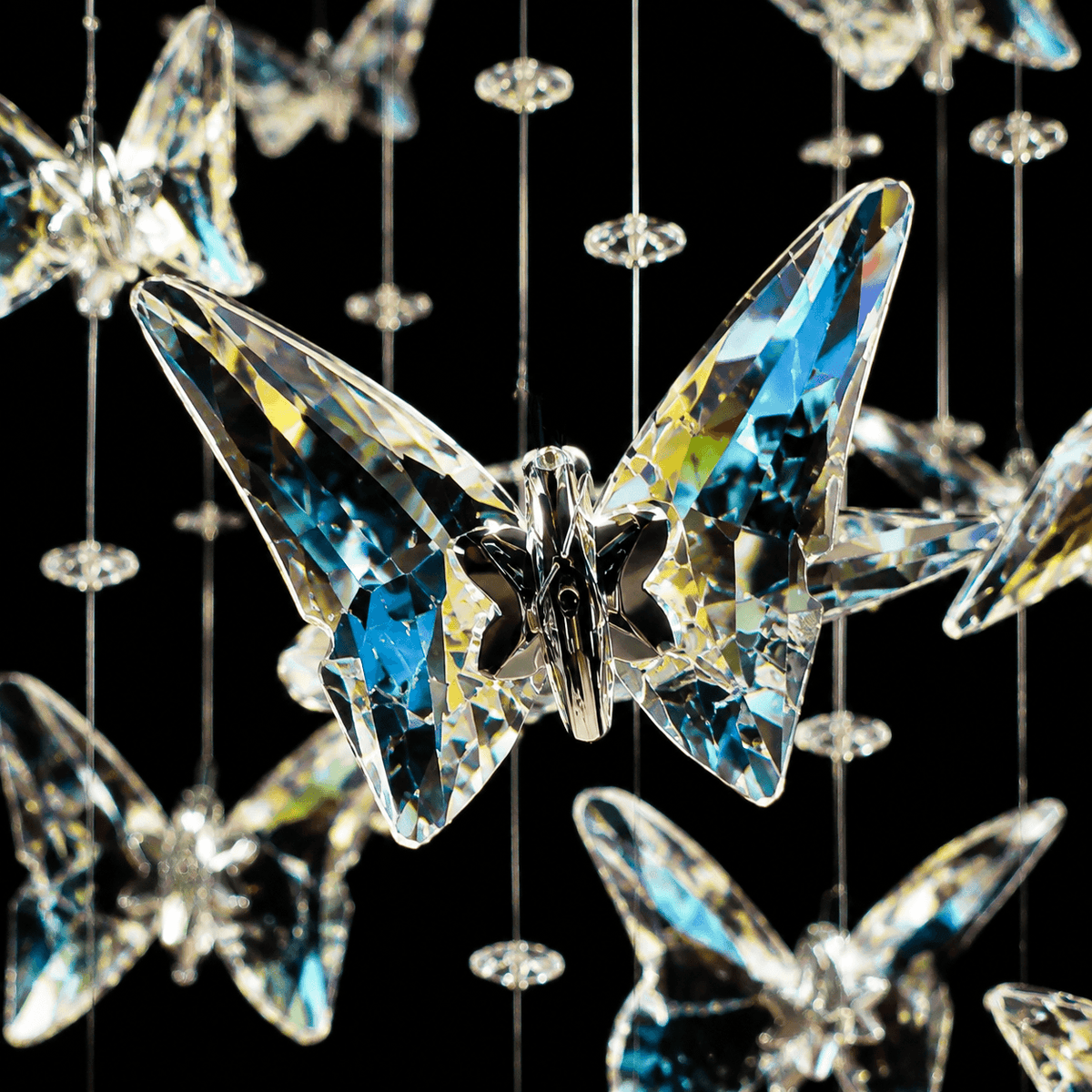 Close-up of Aeris Butterfly Chandelier canopy and wires — polished gold ceiling plate, near-invisible steel wires, hand-hung crystal butterflies, premium build | Sofary Lighting