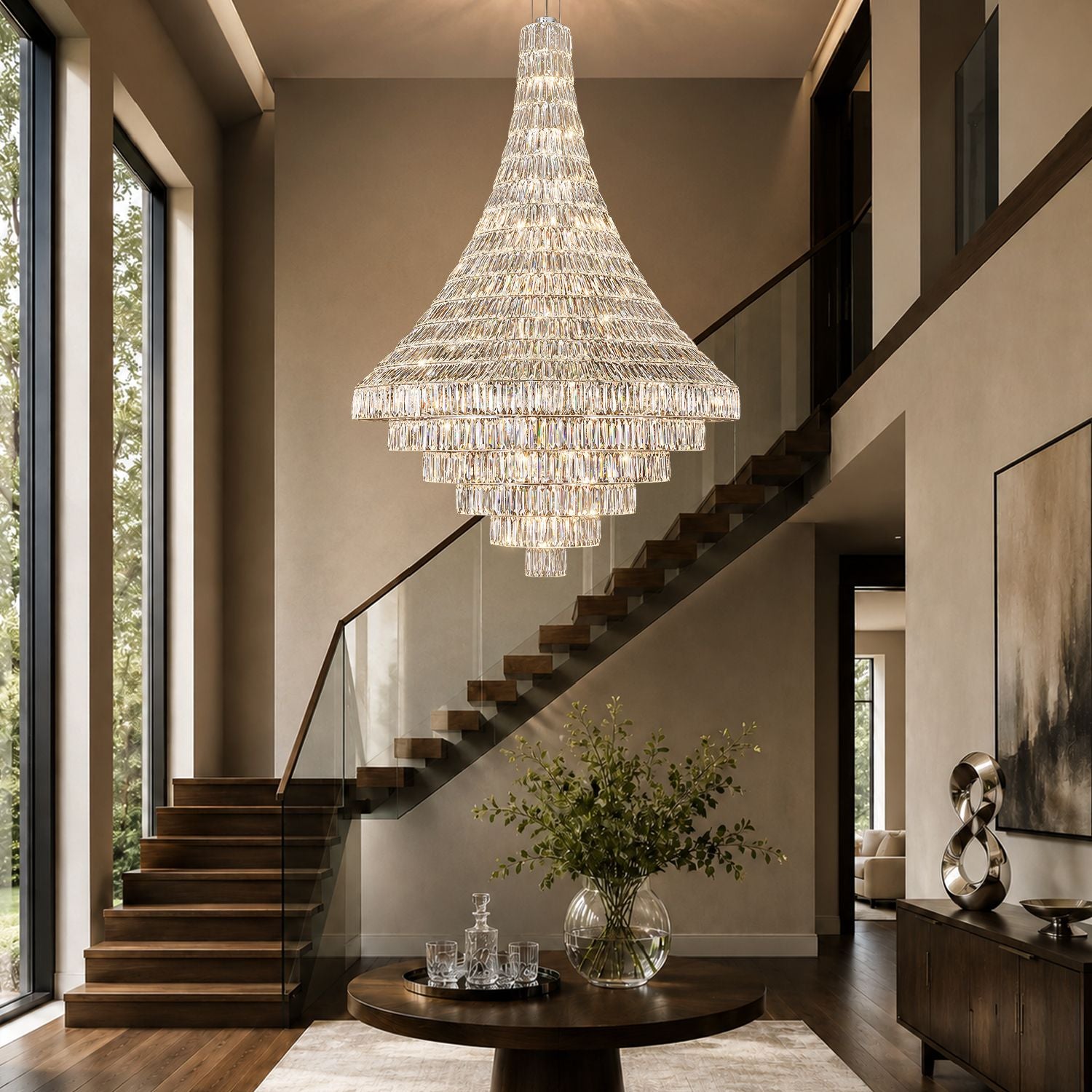 Aerive 39.4" chrome chandelier above modern staircase — luxury crystal waterfall lighting complementing glass railing and wood steps in a grand foyer | Sofary Lighting