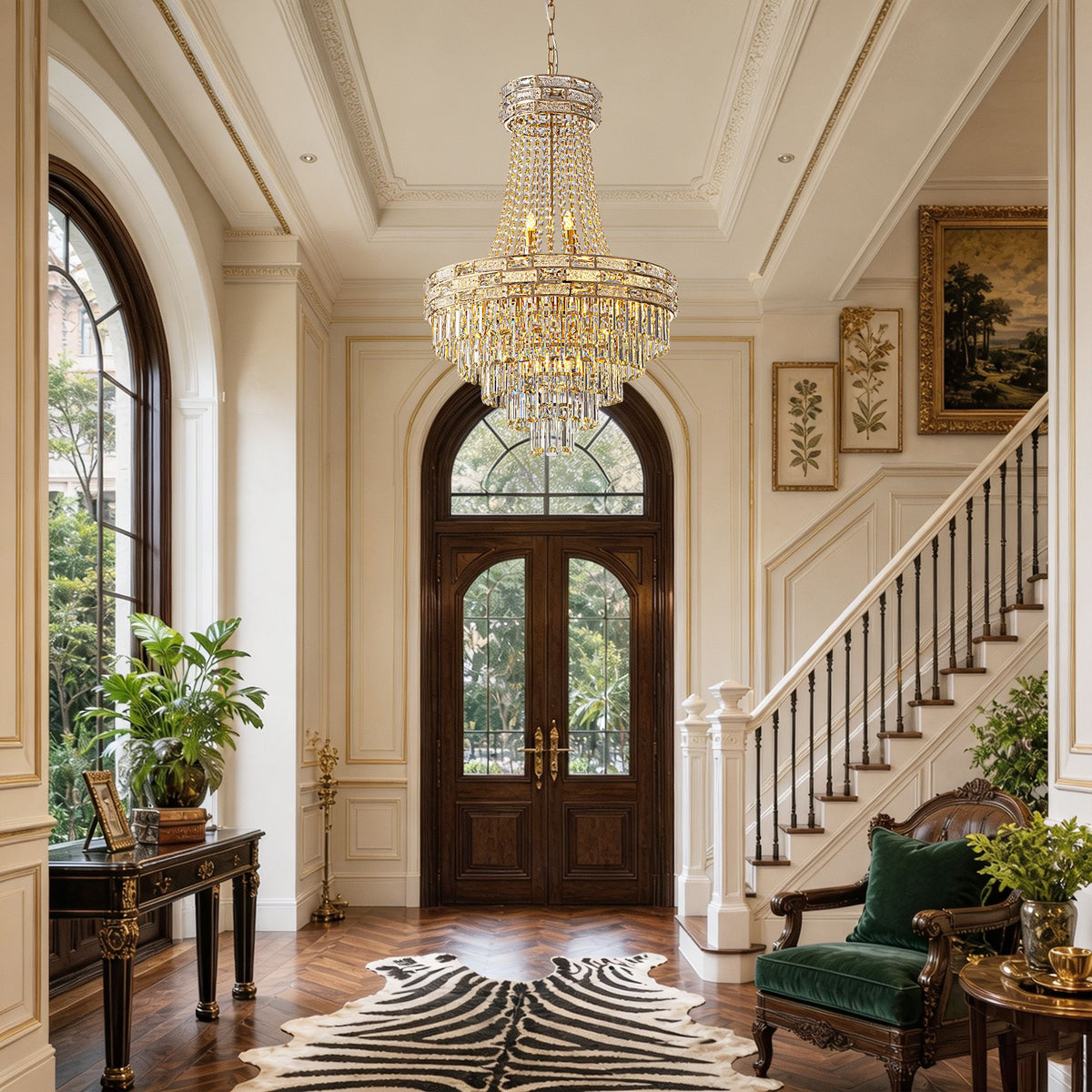 Aeros Empire Gold Crystal Chandelier in spacious entryway — arched glass doors, zebra rug, wood flooring, green velvet chair, cascading crystal drops, luxury home entrance | Sofary Lighting