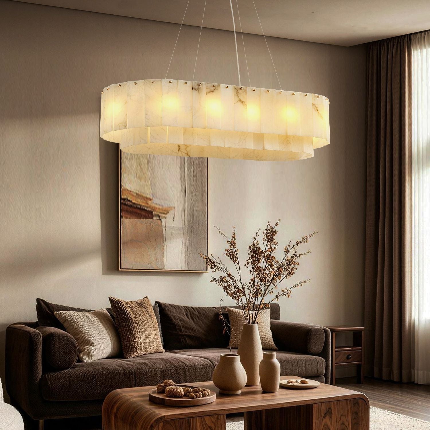 Aethel Modern Natural Alabaster Linear Chandelier in a living room — suspended above a round wooden coffee table with a dark sofa, abstract wall art, and elegant sculptures, creating a warm ambient glow | Sofary Lighting