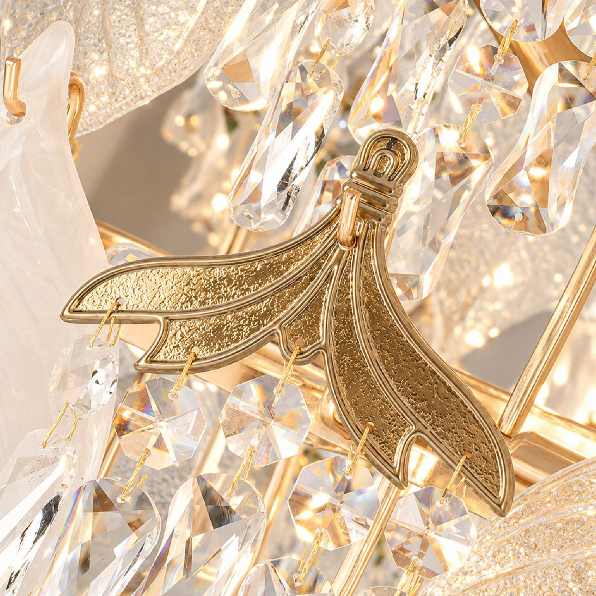 Close-up of Aevum Gold Chandelier structure — gold metal leaf bracket, crystal hangings, premium gold finish, intricate craftsmanship detail | Sofary Lighting