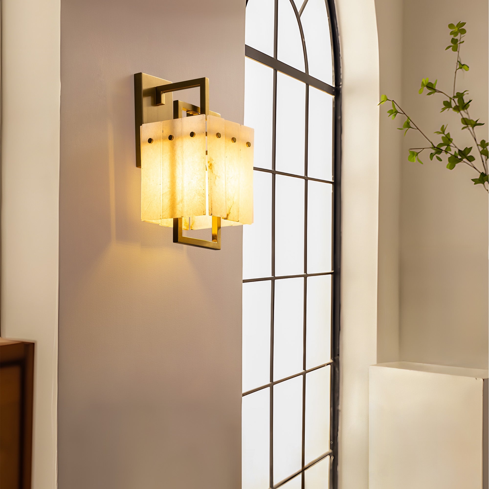 althea-modern-minimalist-brass-alabaster-box-wall-sconce-turn-on-next-to-windows-sofary