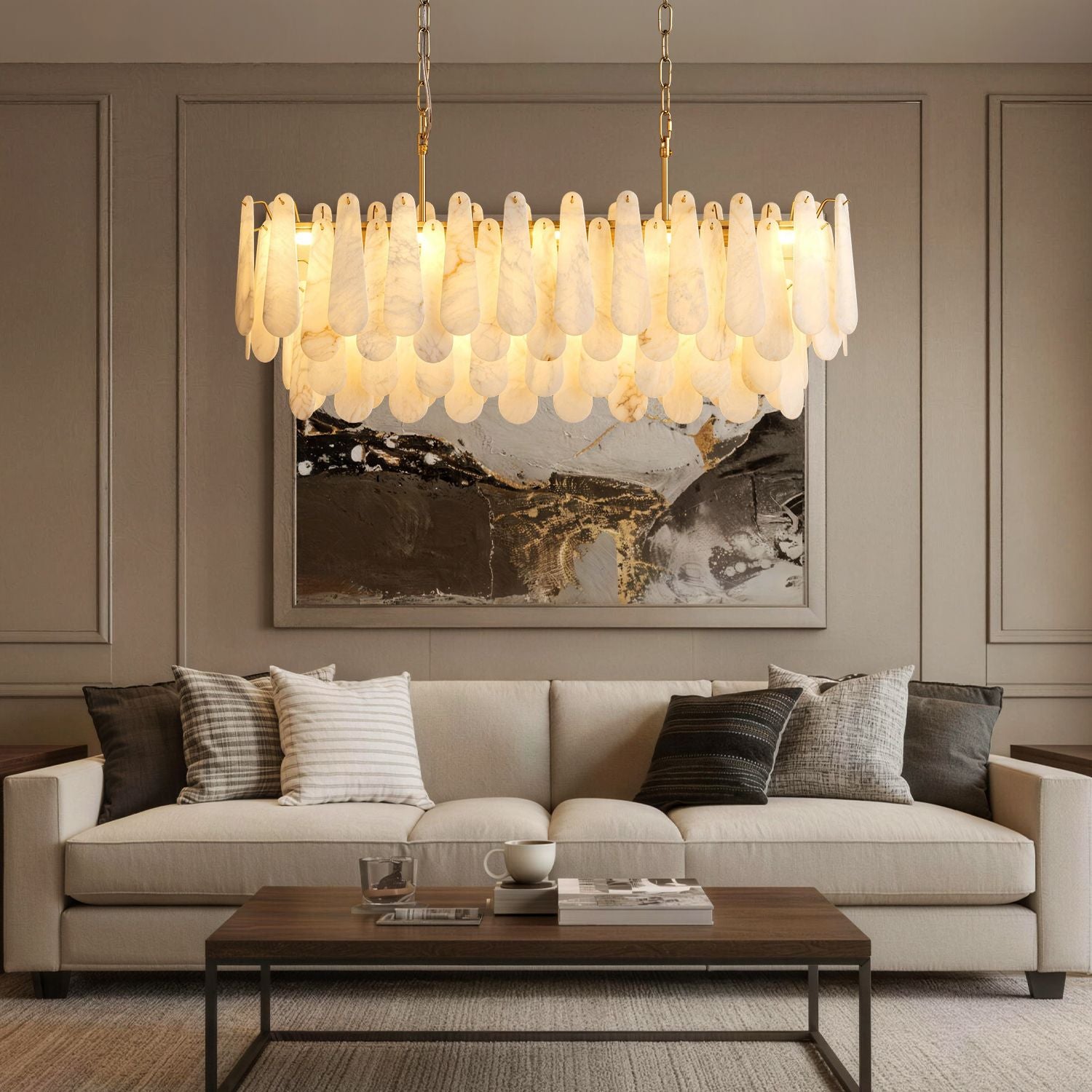 Apex Modern Minimalist Alabaster Linear Chandelier centered above a beige upholstered sofa — set against a dark gray paneled wall with a large abstract painting and a wooden coffee table | Sofary Lighting
