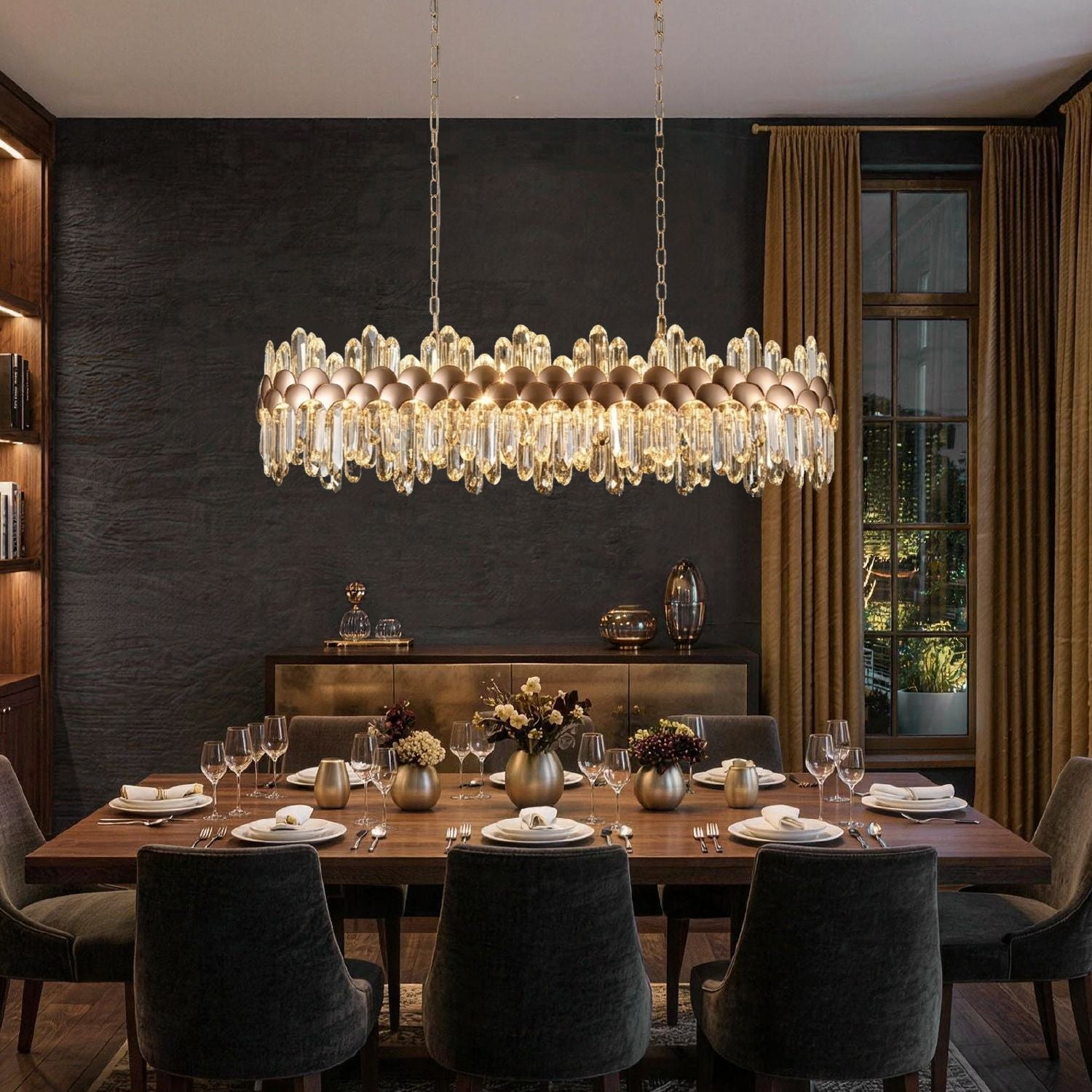 Aurelio Modern Gold K9 Crystal Linear Three-Color Dimming Chandelier glowing against textured black wall, paired with dark velvet chairs and rustic wood table — modern luxury meets dramatic contrast | Sofary Lighting