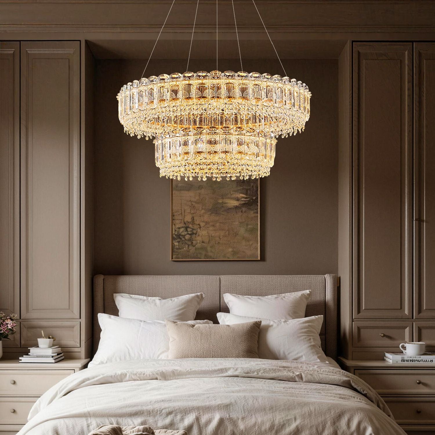 Empire Modern Luxury Gold K9 Crystal Double Tiered Three-Color Dimming Chandelier adds romantic, adjustable ambient light to a serene bedroom, centered above a plush bed with neutral linens and classic wall paneling