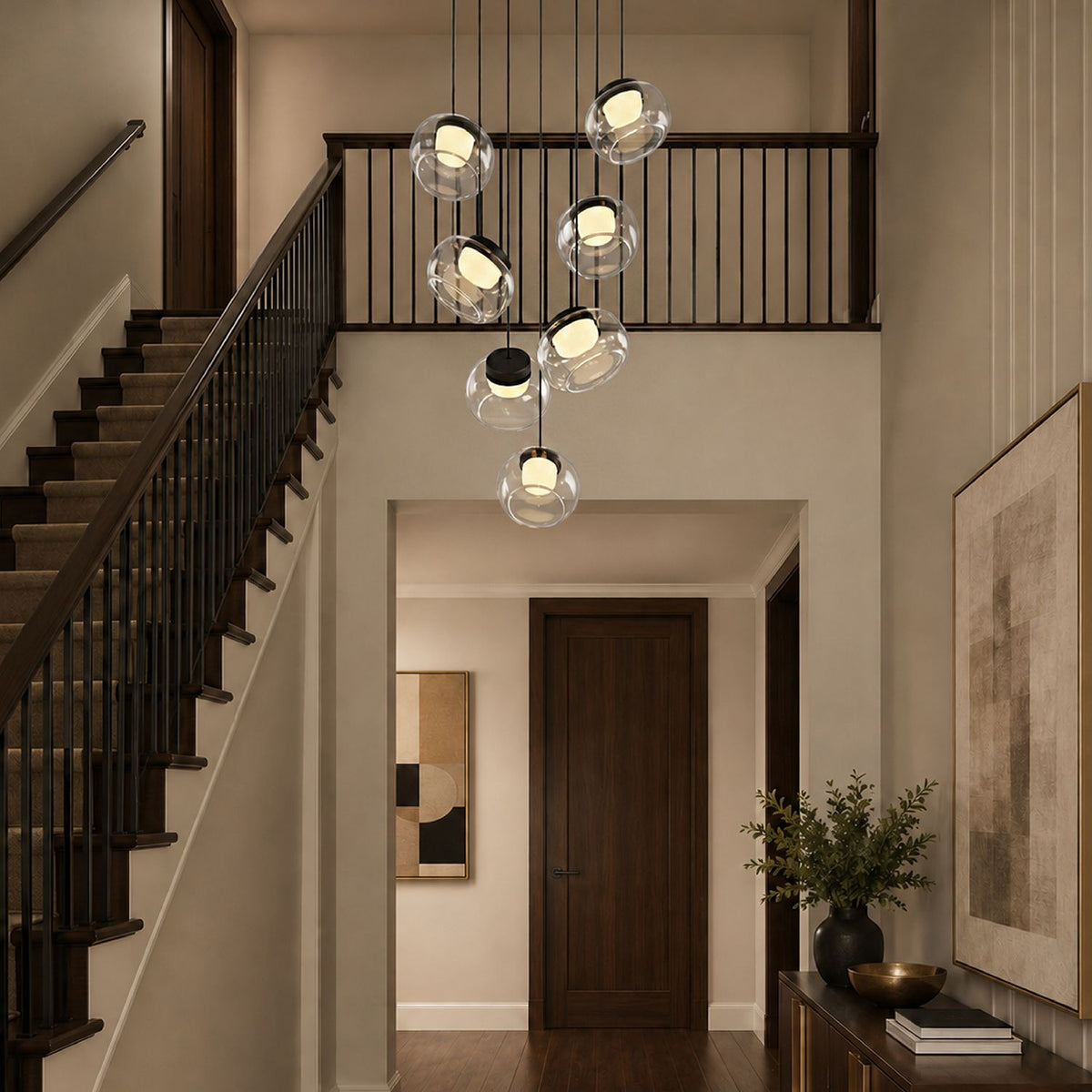 Etherea Cascading Chandelier in a grand staircase setting — high ceilings, black wrought iron railing, natural light from large windows, and elegant glass orbs | Sofary Lighting