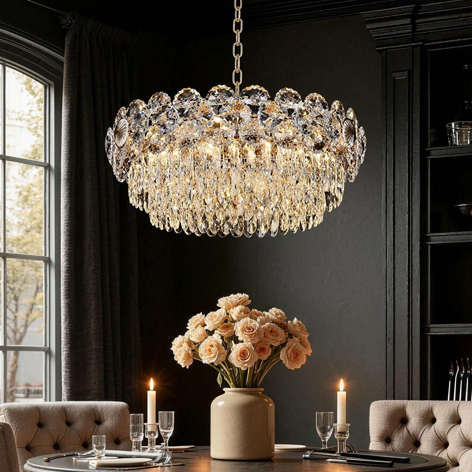 Glacia Modern Luxury Staggered K9 Crystal Flush Mount Chandelier in a dining room — hanging above a round table with pink flowers, candles, and elegant tableware, against a dark paneled wall | Sofary Lighting