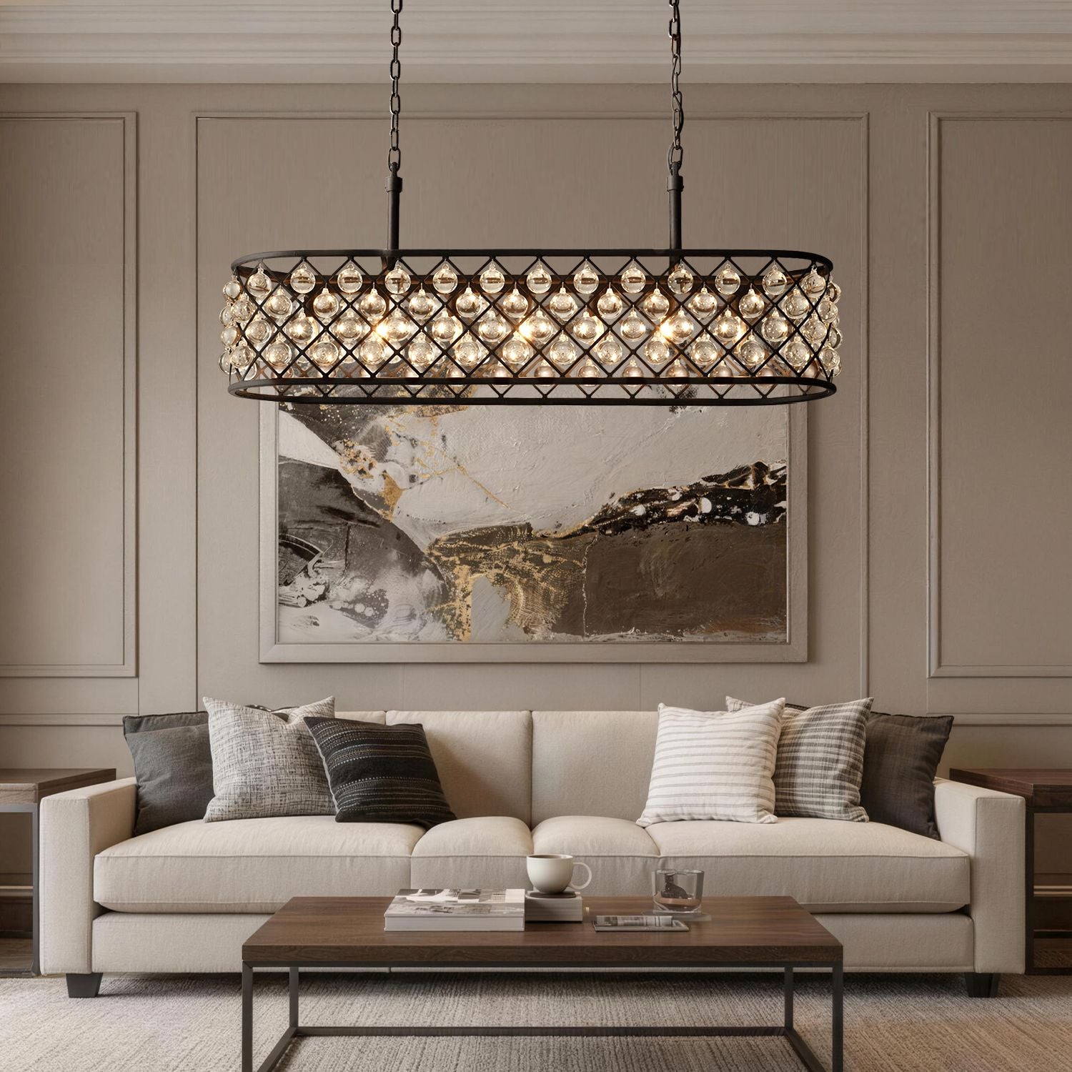 Harlow Modern Industrial Matte Black K9 Crystal Rectangle Chandelier in a living room — suspended above a beige sofa with decorative pillows, a coffee table, and abstract wall art | Sofary Lighting