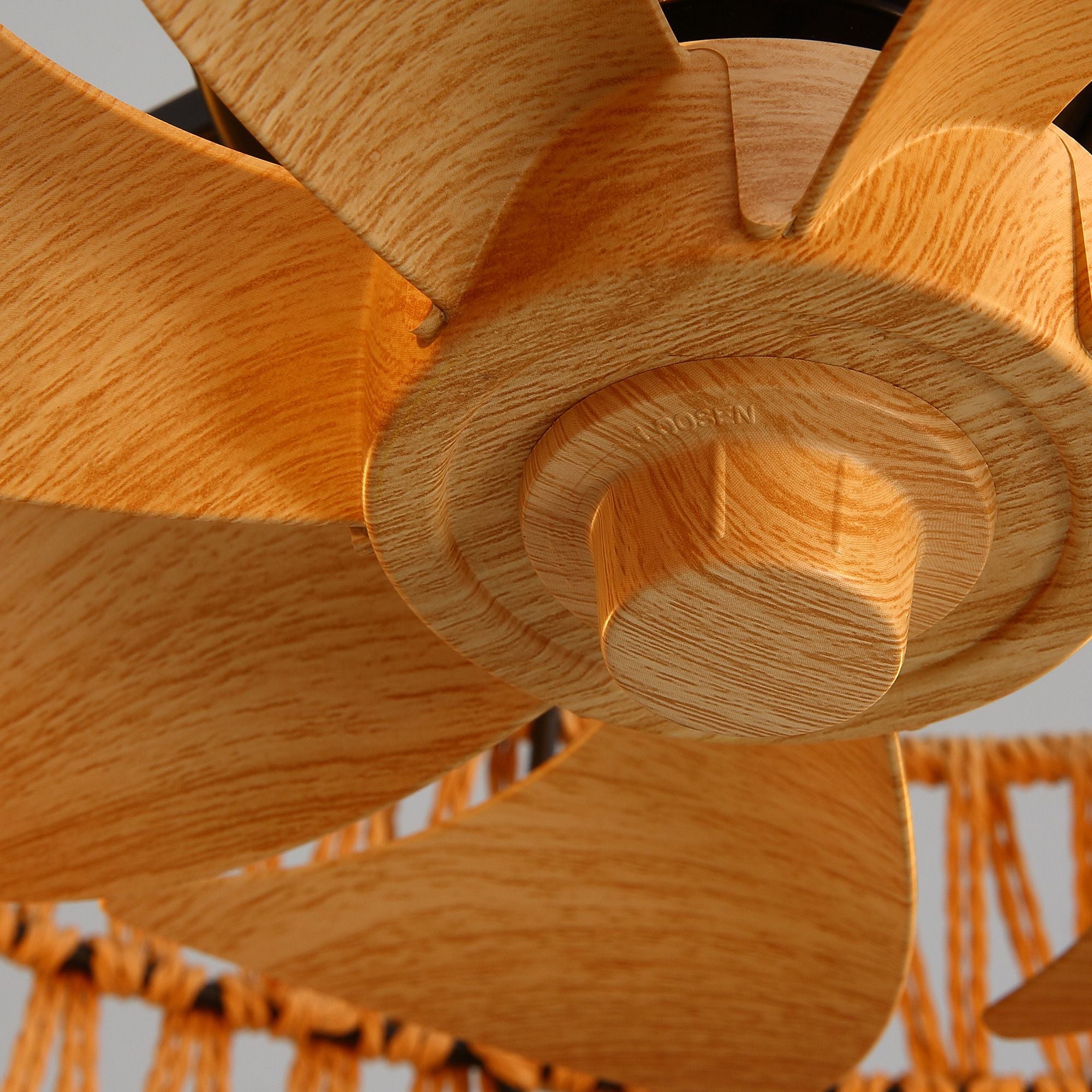 Haven Caged Fan wooden blade detail — natural wood grain finish, aerodynamic paddle design, hidden within rattan cage for safe airflow | Sofary Lighting