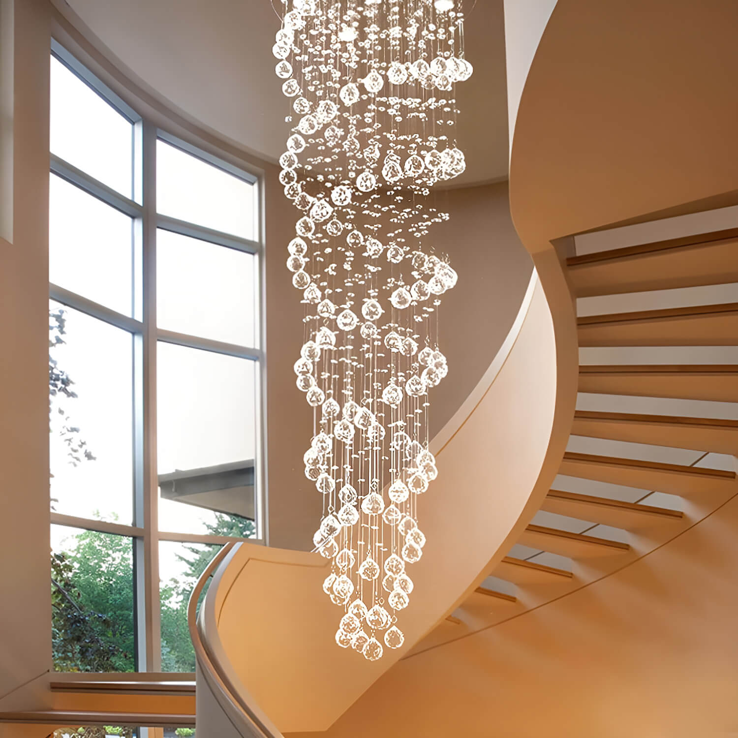 double spiral raindrop crystal chandelier in tall staircase space with large windows and natural light | Sofary