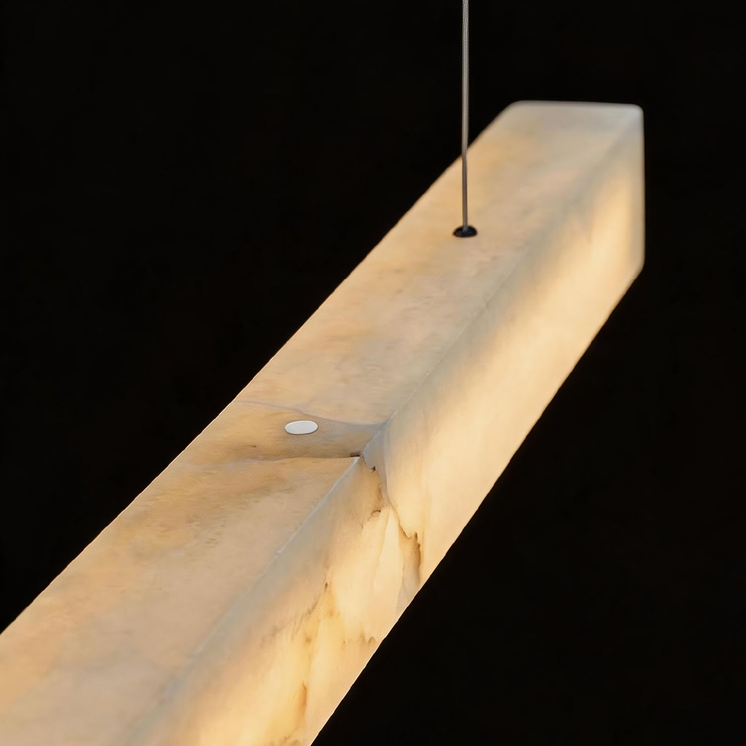 Close-up detail of the Horizon Modern Minimalist Alabaster Ultra-Slim Linear LED Chandelier — showcasing the natural alabaster stone texture with warm, translucent glow and sleek metal frame | Sofary Lighting