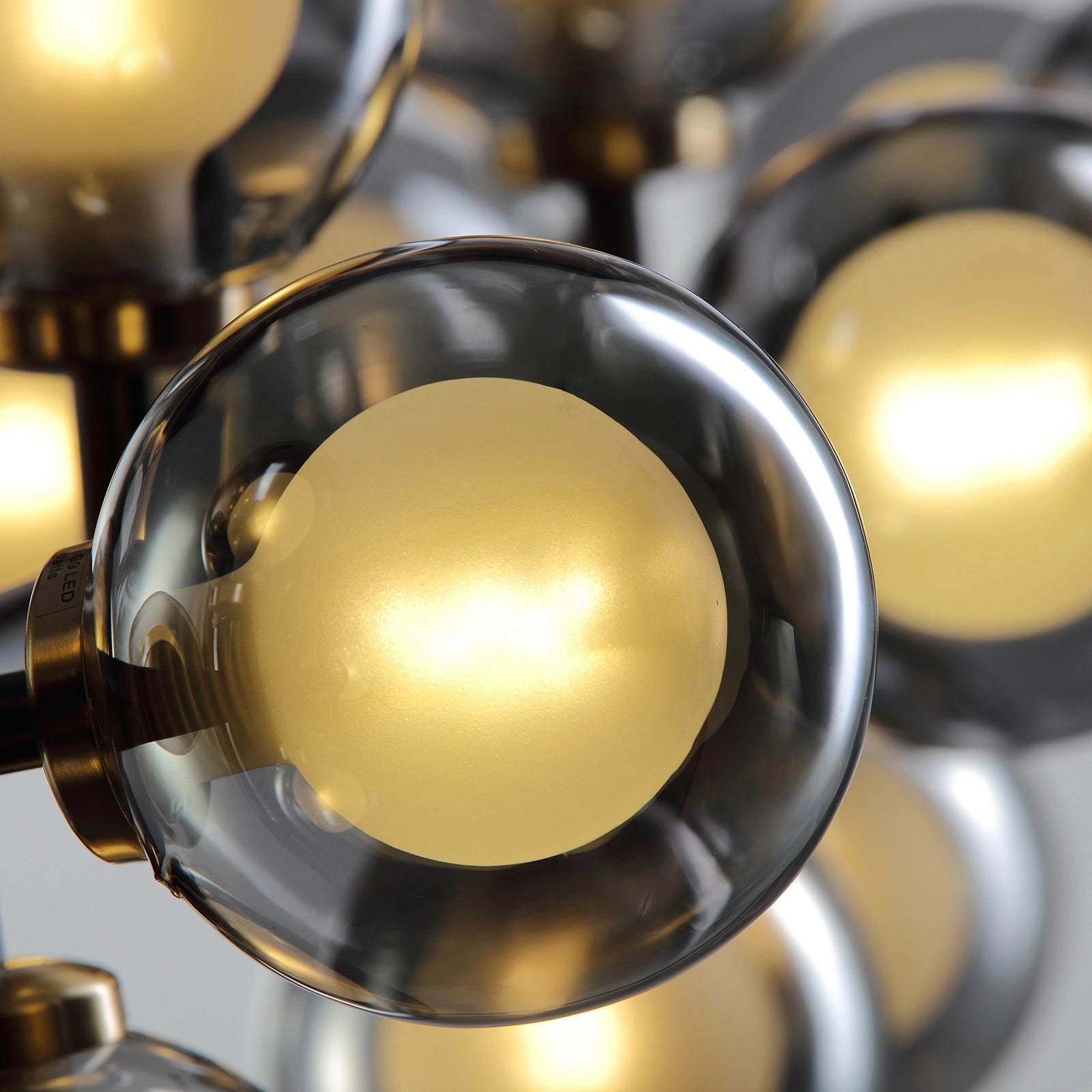 close-up-of-meteor-gray-globe-linear-chandelier-sofary-lighting
