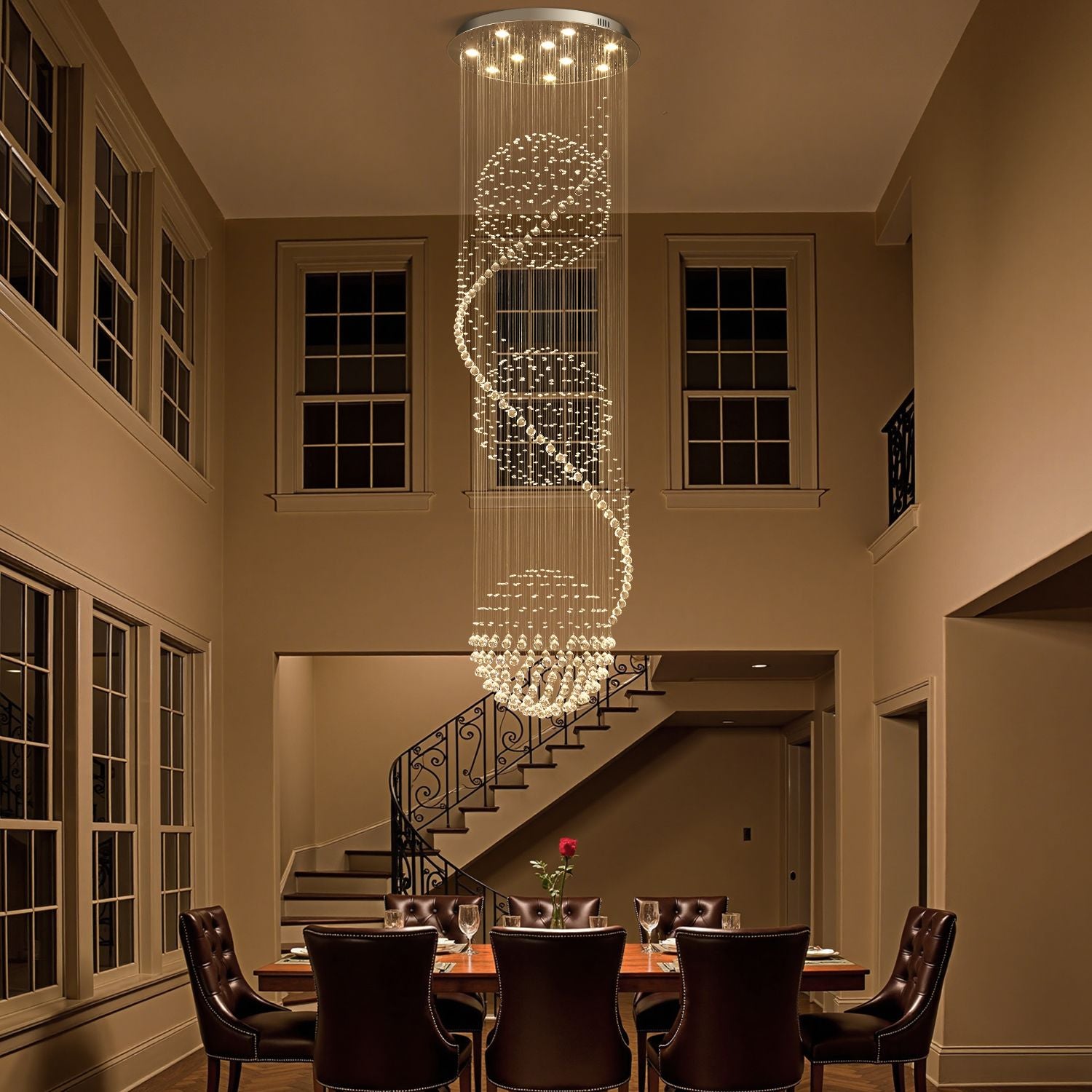 Modern spiral crystal chandelier lighting above a dining table in a luxurious home | Sofary