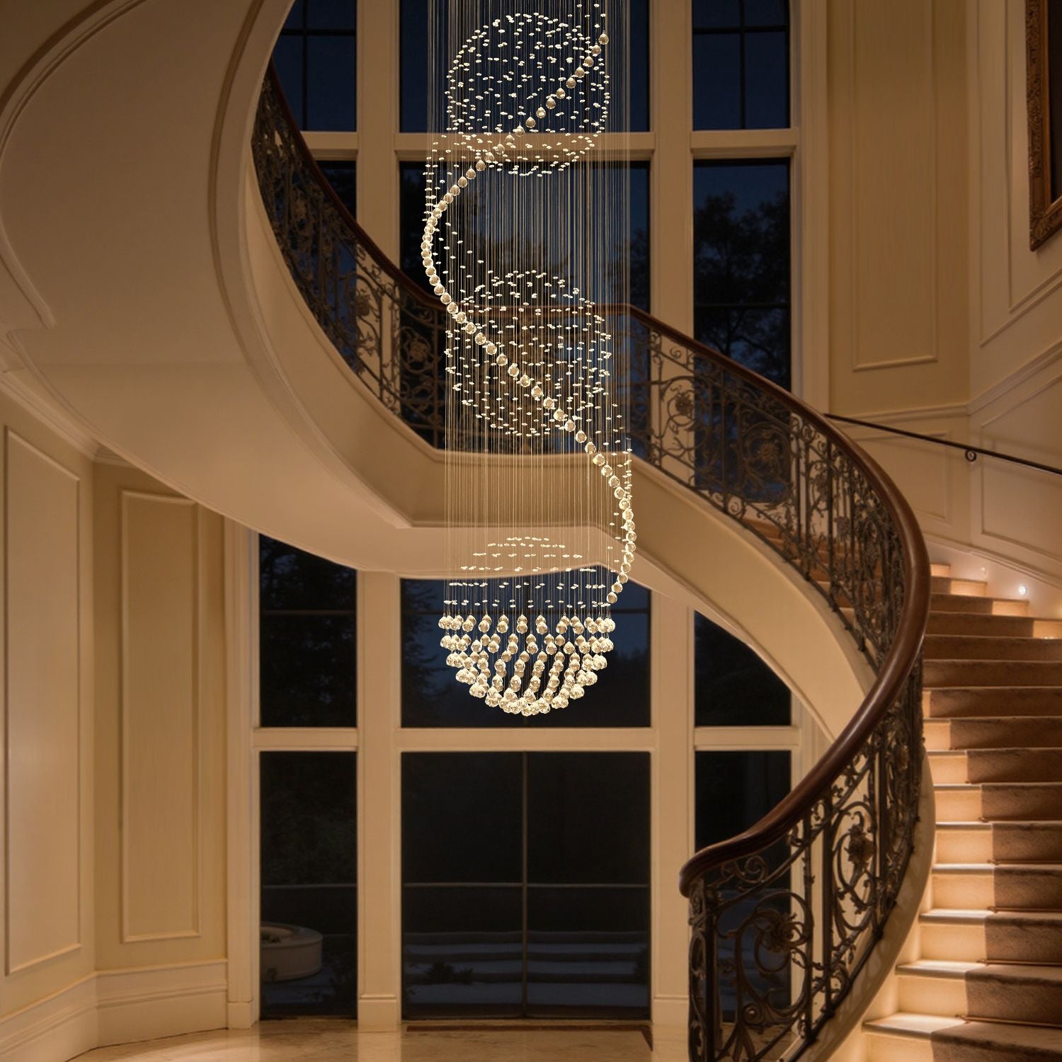 Modern spiral crystal chandelier with three spheres illuminating a stairwell | Sofary
