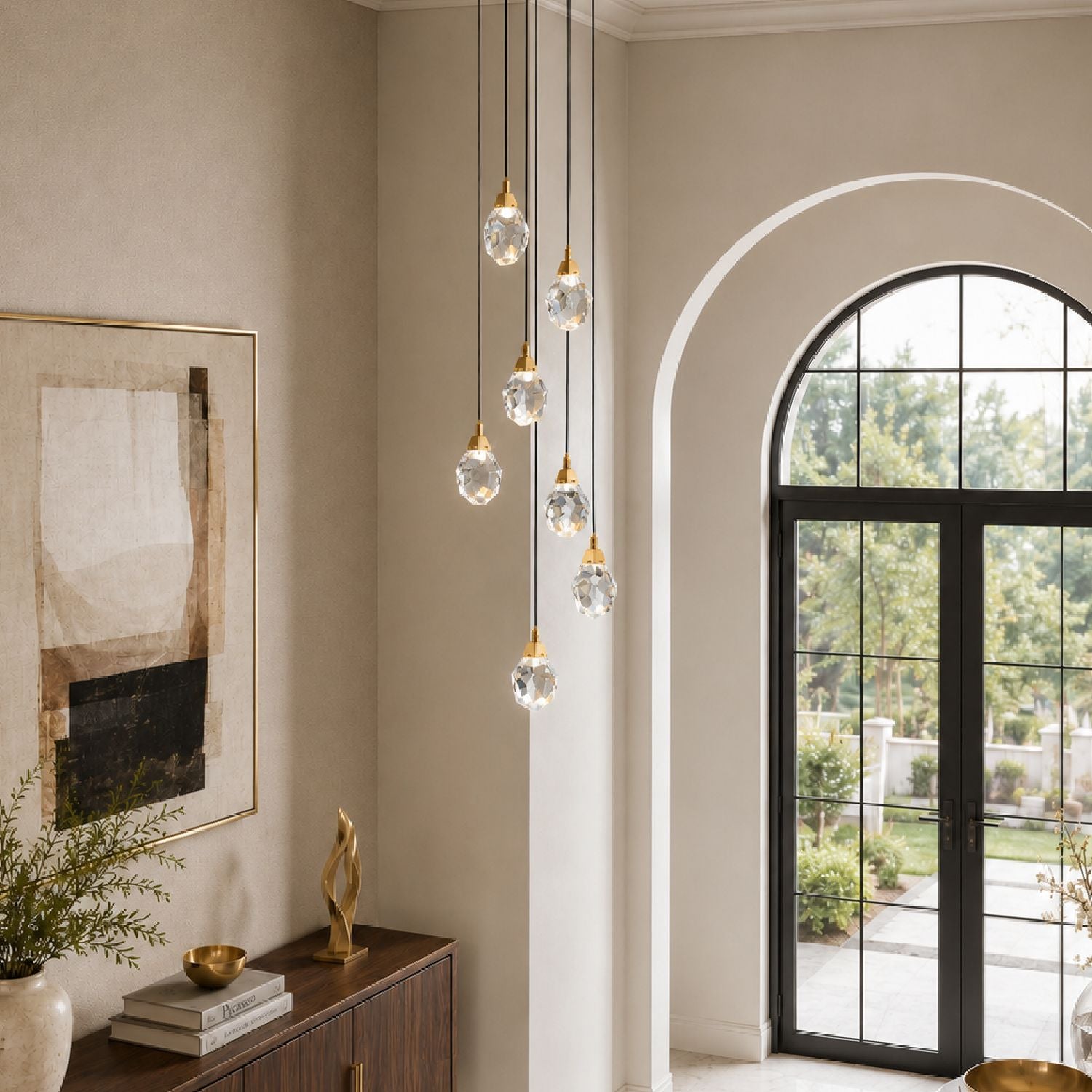 Nirvana Chandelier in a grand foyer — dark wood staircase, arched doorway, potted greenery, and cascading crystal lights enhancing architectural elegance | Sofary Lighting