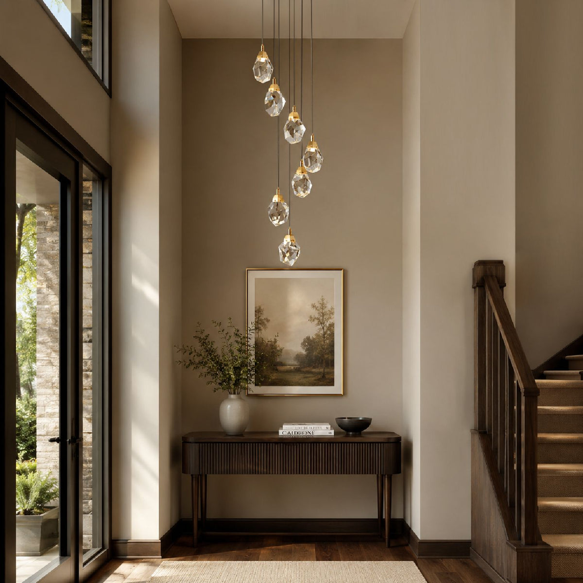 Nirvana Chandelier in a bright foyer — large abstract painting, wooden console table, floor-to-ceiling windows, and natural light complementing crystal glow | Sofary Lighting