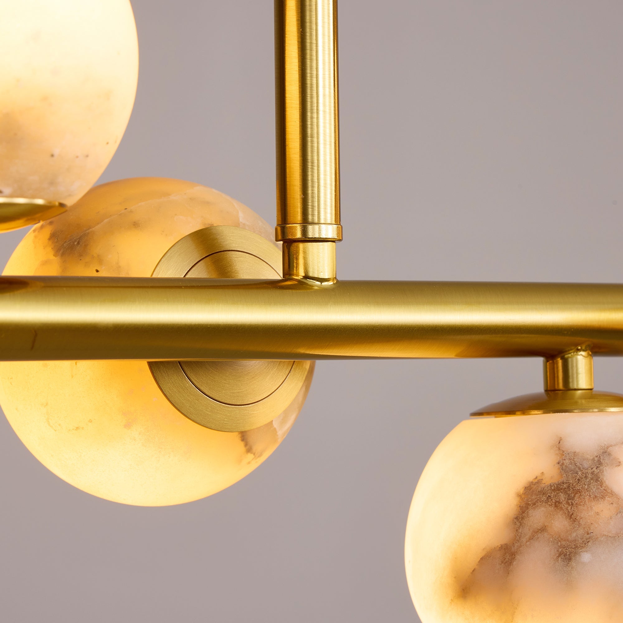 orbelia modern luxury gold alabaster globe linear chandelier gold frame connection detail