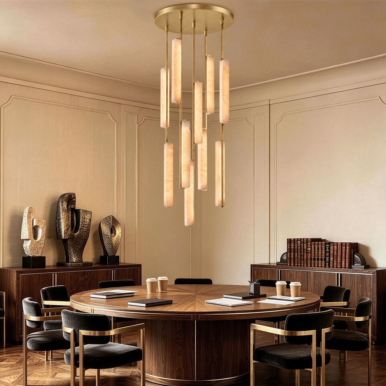 Stamen Modern Minimalist Alabaster Vertical Chandelier in a commercial conference room — hanging above a circular wooden table with modern decor, bookshelves, and sophisticated lighting