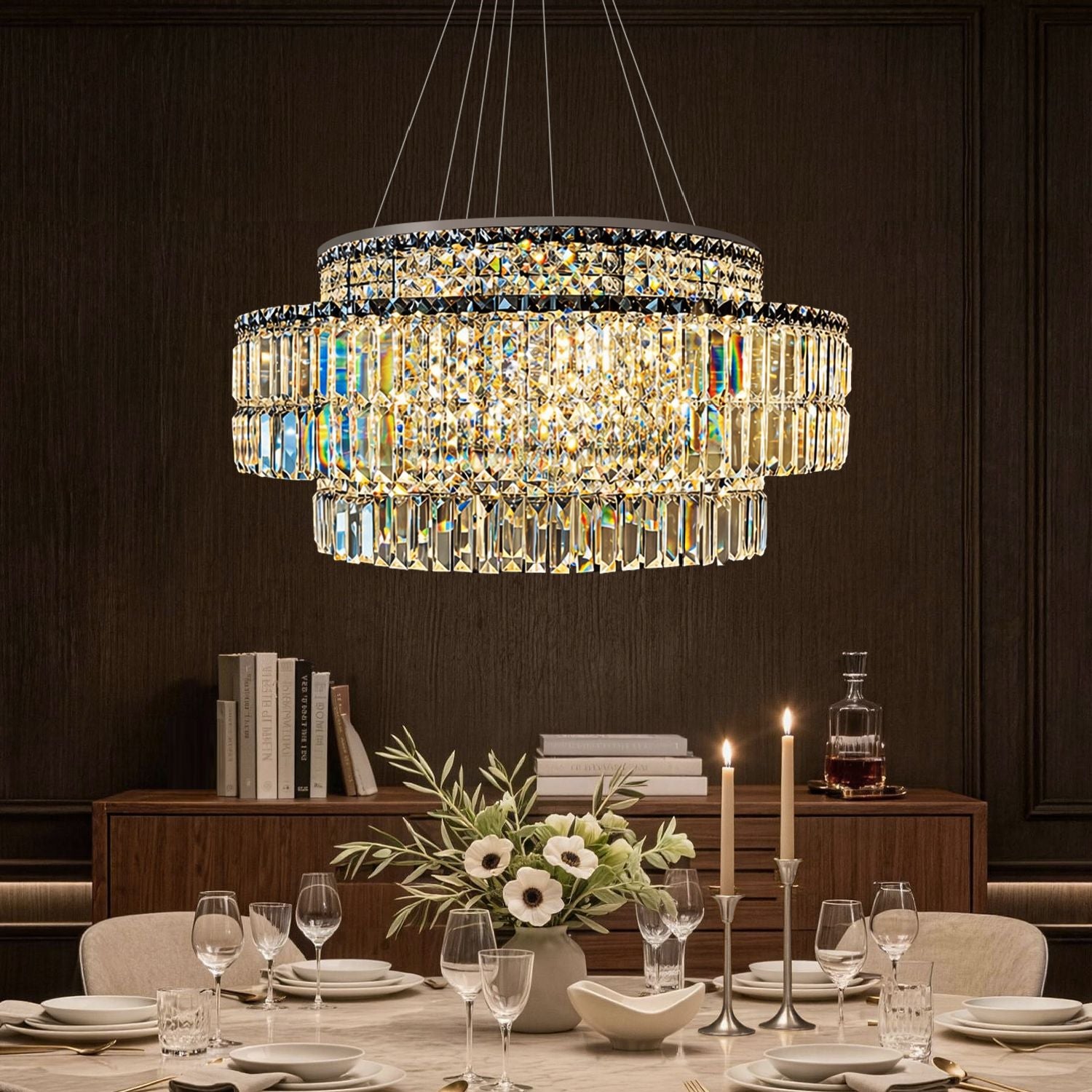 Stellar Modern Silver Multi-Faceted K9 Crystal Round Chandelier in a dining room — hanging above a marble table with white flowers, elegant tableware, and a dark paneled wall backdrop | Sofary Lighting