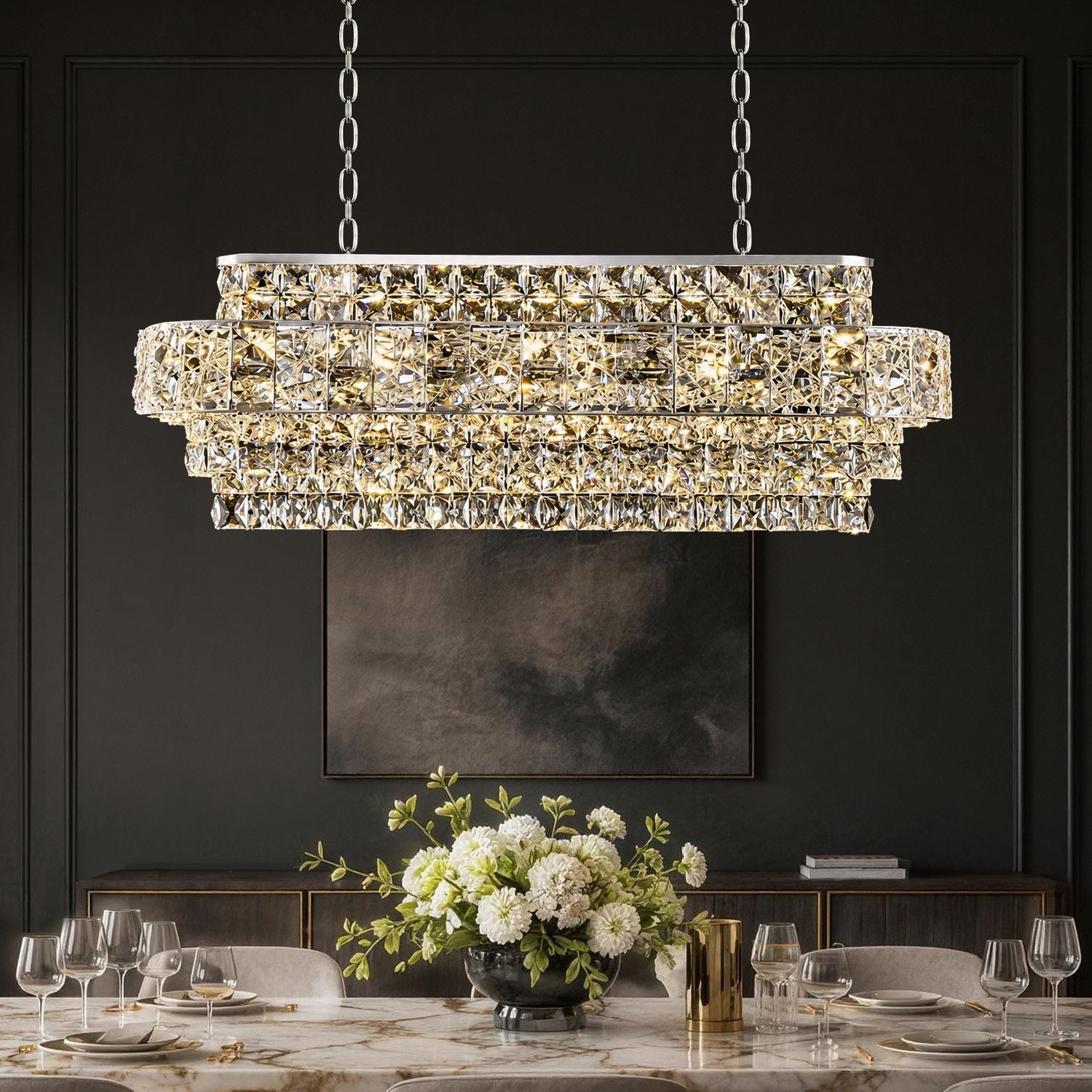 Valeria Linear Luxury K9 Crystal Chandelier in a dining room — illuminating a marble dining table set with a grand bouquet of white flowers, elegant dinnerware, and wine glasses