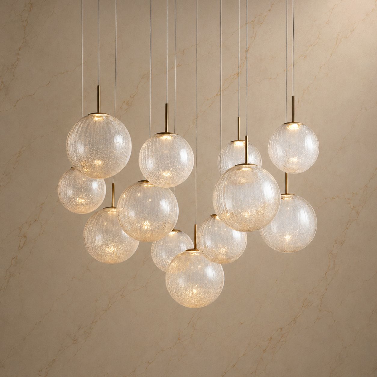 Veritas Sculptural Chandelier illuminated — warm glow through textured glass globes, brass fixtures, modern luxury | Sofary Lighting