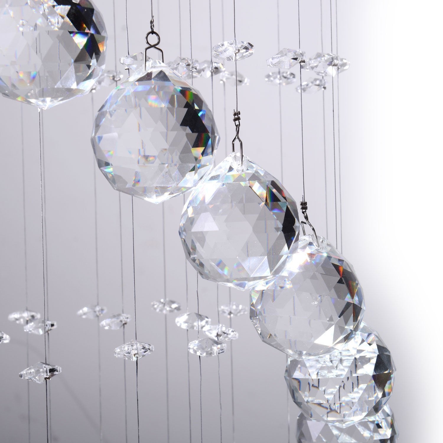 close up of k9 crystal raindrop prisms on spiral chandelier reflecting light and rainbow effects | Sofary